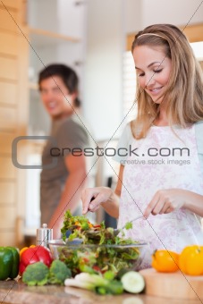 Portrait of a lovely couple making a salad