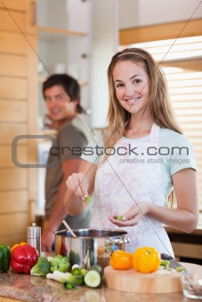 Portrait of a smiling couple cooking