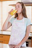 Portrait of a woman drinking orange juice