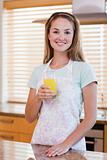 Portrait of a young woman drinking orange juice