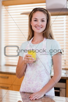 Portrait of a young woman drinking orange juice