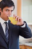 Portrait of a businessman drinking orange juice