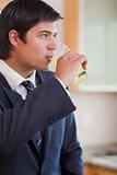 Portrait of a young businessman drinking orange juice