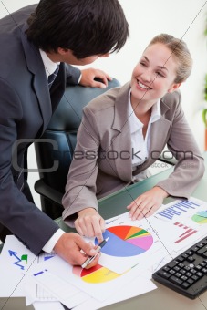 Portrait of a young business team studying statistics