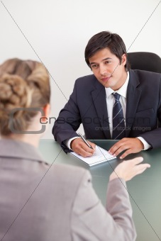 Portrait of a smiling manager interviewing a female applicant