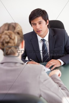 Portrait of a serious manager interviewing a female applicant