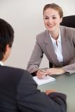 Portrait of a smiling manager interviewing a male applicant