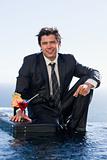 Portrait of a businessman posing with a cocktail in a briefcase