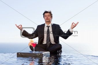 Businessman relaxing in the lotus position
