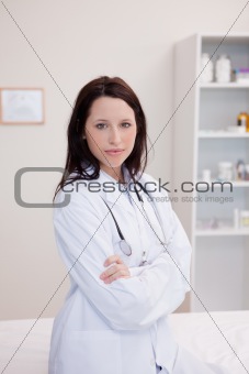 Female physician with folded arms