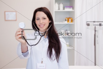 Smiling female doctor using stethoscope