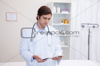 Male doctor working on tablet