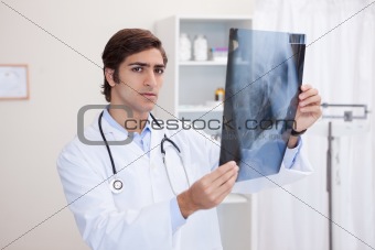 Male doctor analyzing x-ray