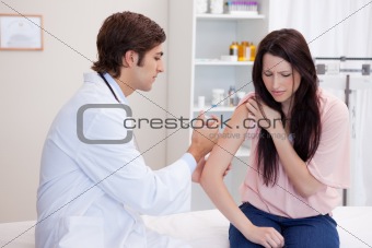 Male doctor giving patient an injection
