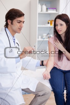 Doctor about to give an injection to patient