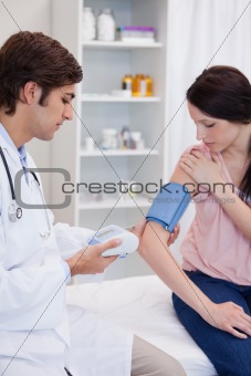 Doctor analyzing patients blood pressure