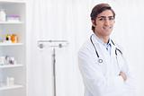 Smiling doctor standing in examination room