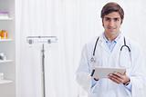 Smiling doctor with tablet