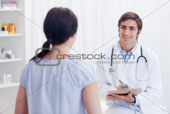 Smiling physician talking with patient