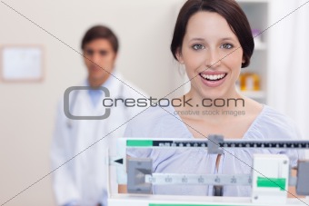 Smiling woman on the scale