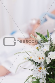 Flowers next to woman about to get surgery