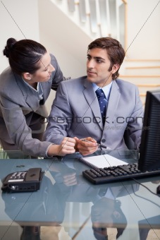 Businesswoman explaining something to her colleague