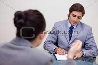 Businessman in negotiation taking notes