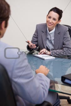 Smiling businesswoman with notepad in negotiation