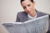 Newspaper being read by businesswoman