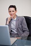 Smiling businesswoman sitting in her office
