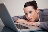 Businesswoman leaning against her laptop