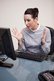 Businesswoman seems to be surprised by computer