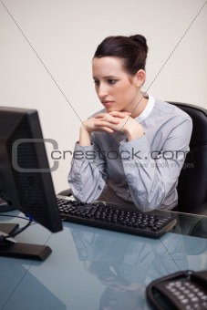 Businesswoman staring at her computer screen