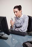 Businesswoman at her desk with a glass of water