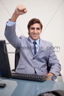 Businessman raising his fist in success