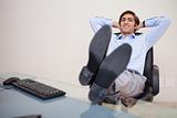 Smiling businessman leaning back in his chair
