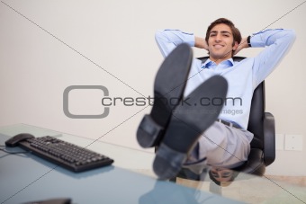 Smiling businessman leaning back in his chair