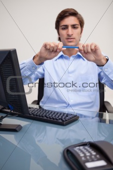 Businessman about to break his pencil