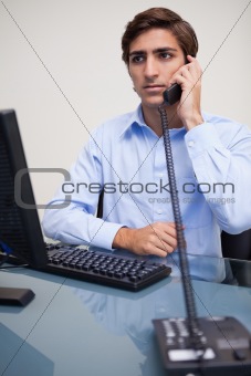 Serious looking businessman on the phone