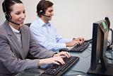 Side view of call center agents working next to each other