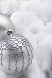 Silver baubles in snow