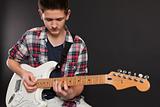 Young male playing electric guitar