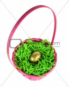 golden egg nestled in a pink easter basket