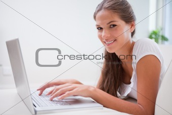 Side view of woman on her laptop