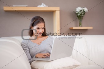 Woman with notebook on her sofa