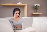 Woman with headphones on her laptop