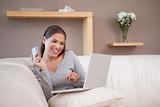 Woman shopping online on her sofa