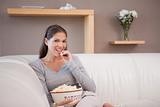 Woman eating popcorn while watching movie