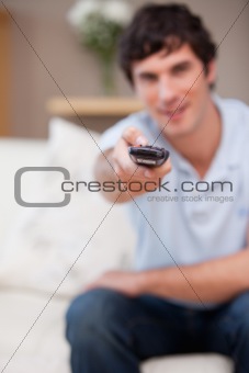Remote being used by man on the sofa