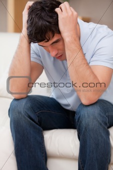 Frustrated man sitting on the couch